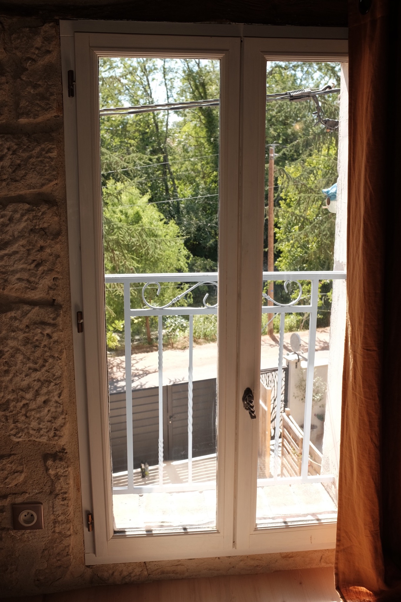 French casement window opening onto greenery
