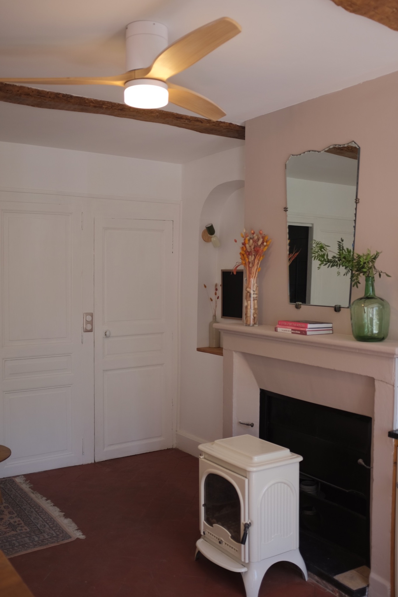 Blush living room with original fireplace and cream wood-burning stove