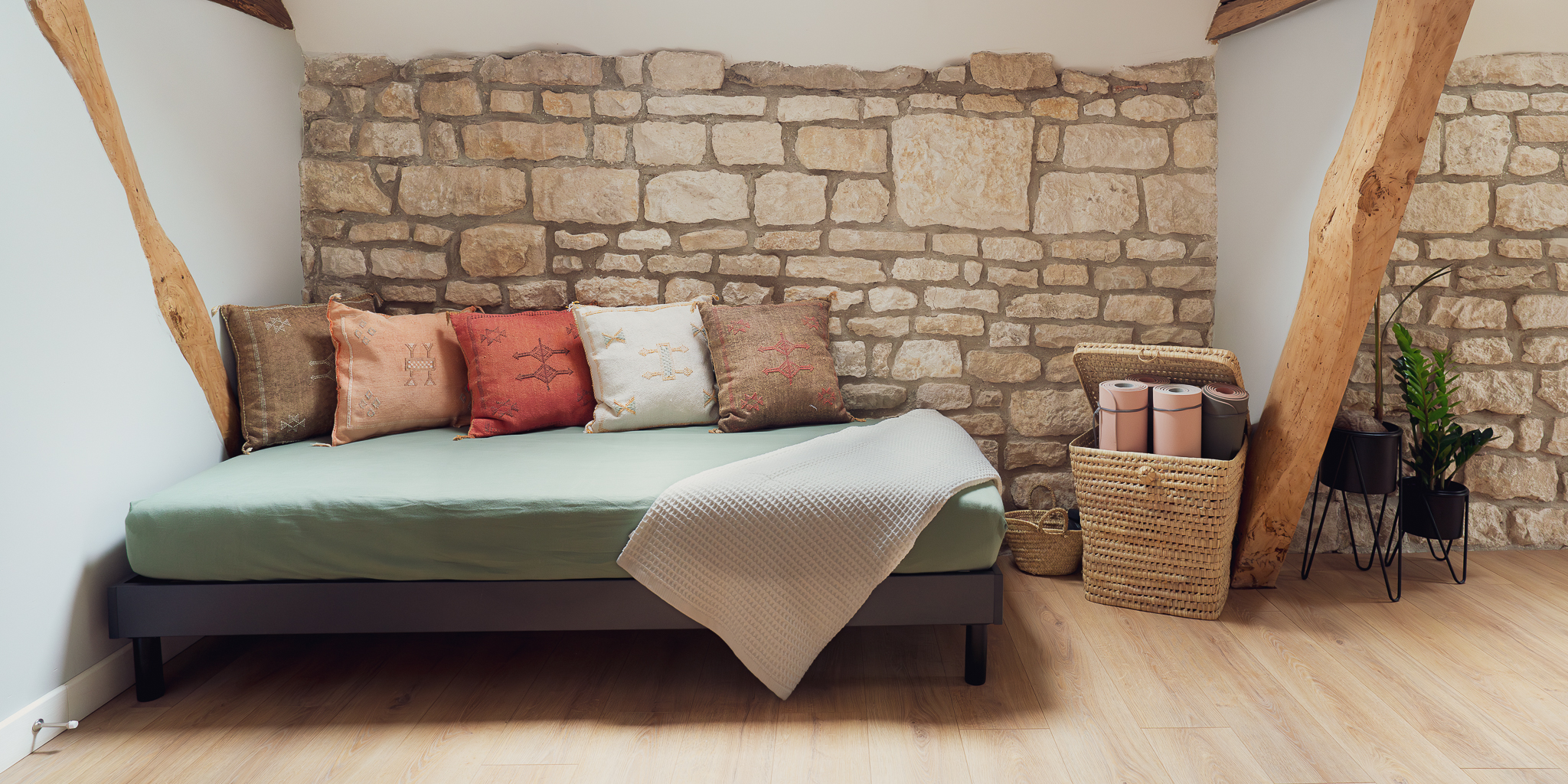 Daybed with yoga mats and indoor plants