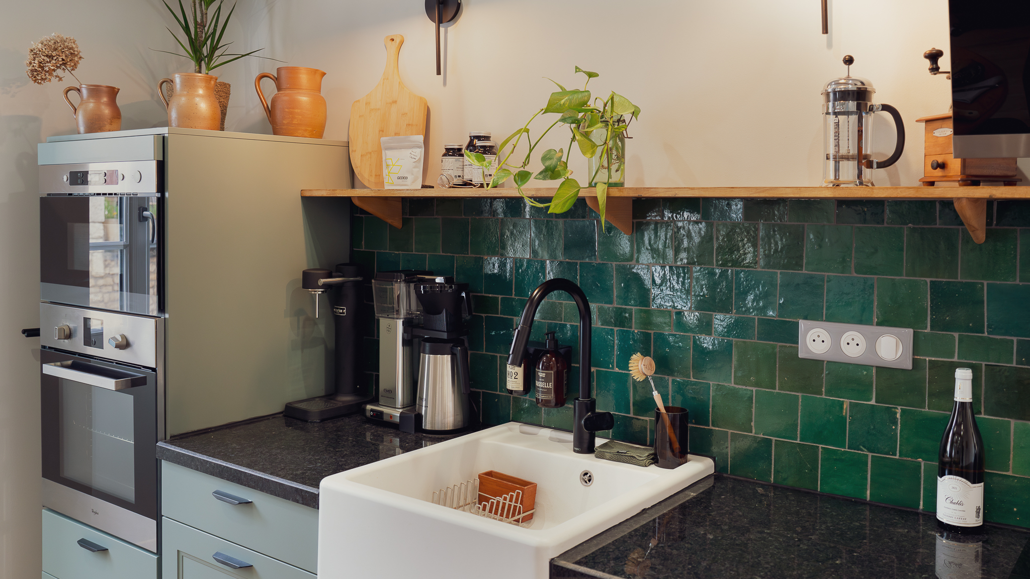 Sage green kitchen with emerald tile backsplash